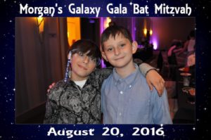 two boys pose for a picture at a bat mitzvah