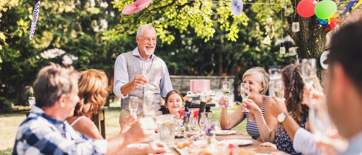 Family celebration outside in the backyard. Big garden party.